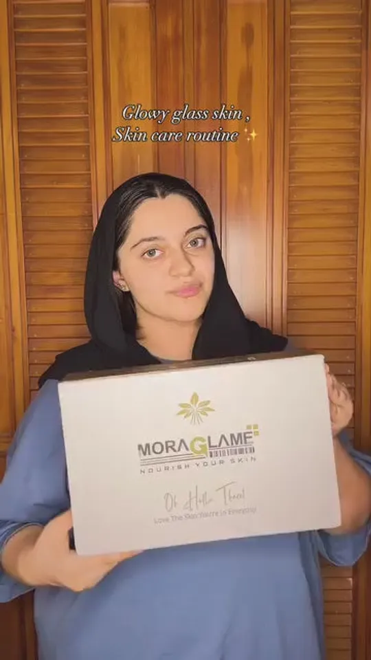 A creator holding a MoraGlame gift box, captioned “Glowy glass skin, skin care routine”
